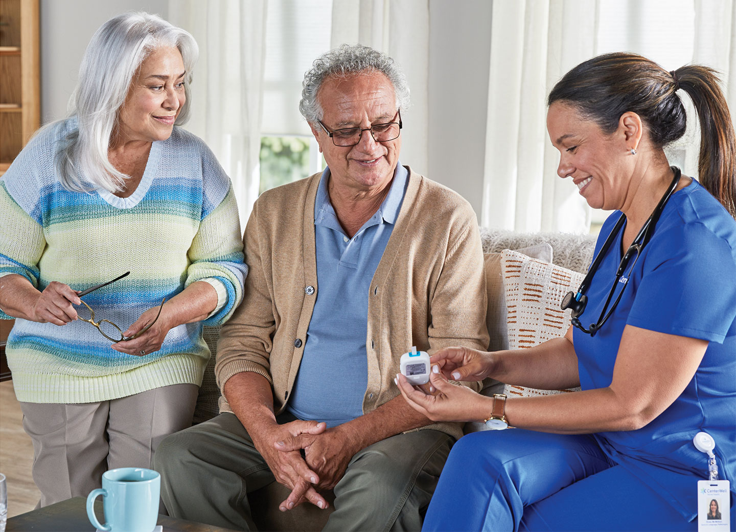 A CenterWell Home Health clinician warmly greeting a patient as he arrives at her home