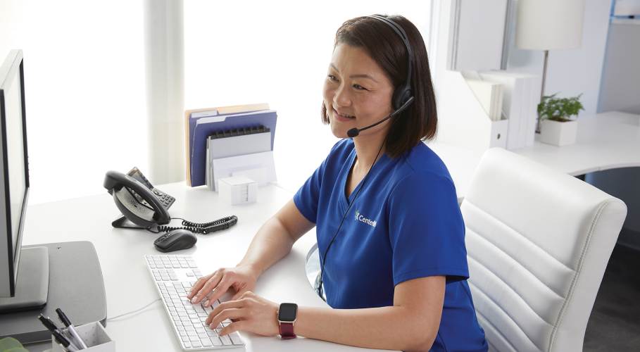 Female clinician happily receives patient calls at the office